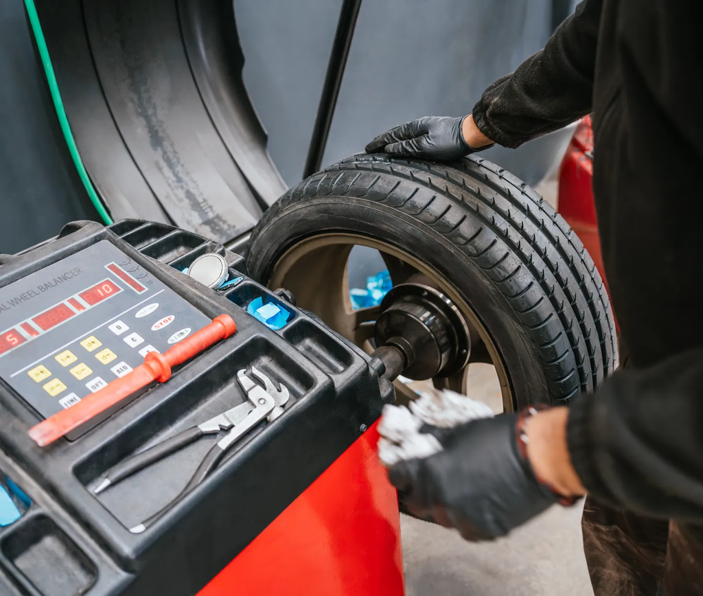 Technician checking wheel balance