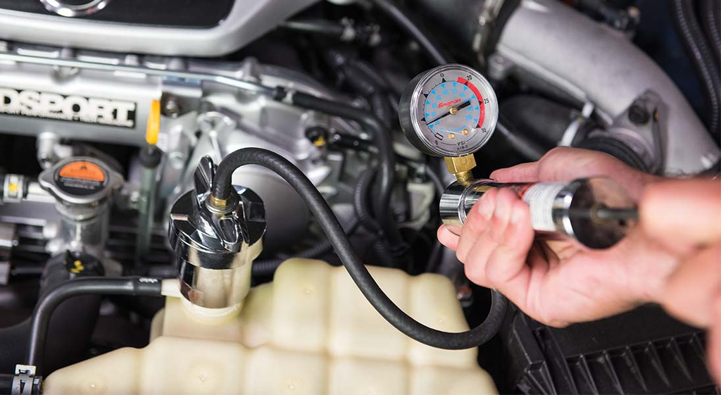 Technician pressure testing a cooling system