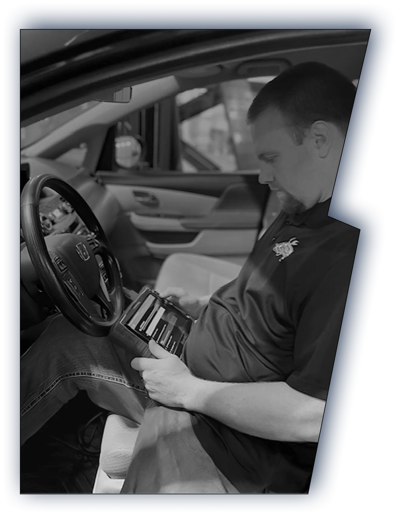 Mason Automotive technician running diagnostics inside a vehicle